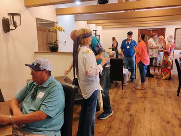 People enjoying charcuterie and beverages and conversation.