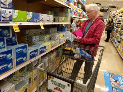 Volunteer shopping for a neighbor.