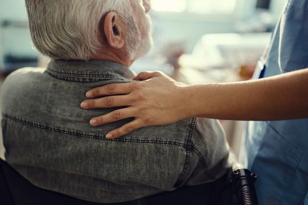 Image of someone putting a helping hand on another persons back