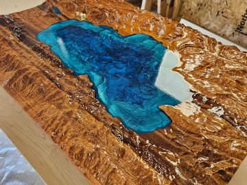 Wooden table with blue resin lake inlay.