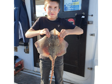 Merlin's future Skipper Dylan (eldest son)with his 1st Thornback Ray