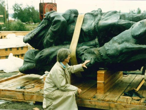 Sculpture Artist Malcolm Alexander inspects the Unknown First Family Statue at Golden Heart Plaza.