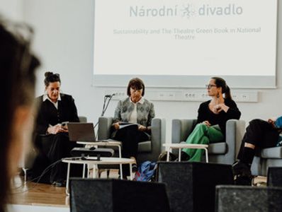 Panel discussion on sustainability at the National Theatre with four participants seated on stage.