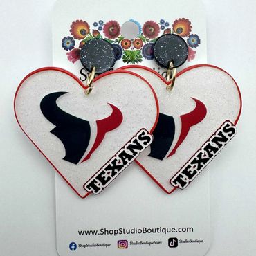 Heart-shaped Texans earrings with black and red bull logos.