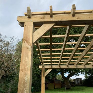 Pergola with checker-board trellis installed on top