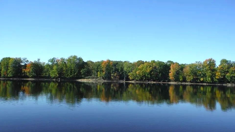 View of the calm lake from the doc on a sunny morning.