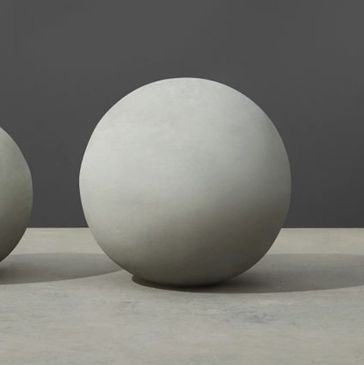 Two smooth, round concrete spheres of different sizes on a gray surface. bancas de acero inoxidable
papeleras
paradas