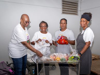 Five people, stand together holding a donation.
