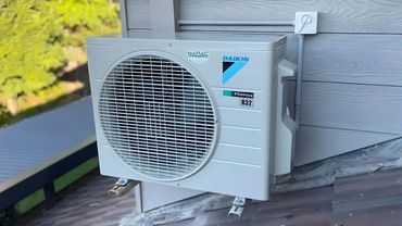 Daikin outdoor heat pump unit professionally installed on Maine home rooftop by Bangor HVAC