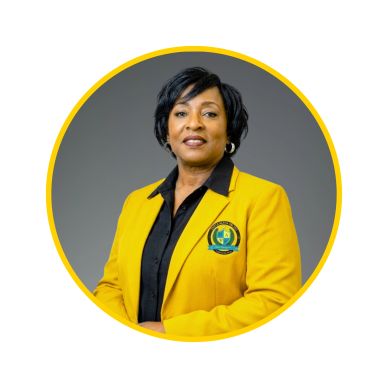 Professional woman in a yellow blazer with a logo, posing confidently.