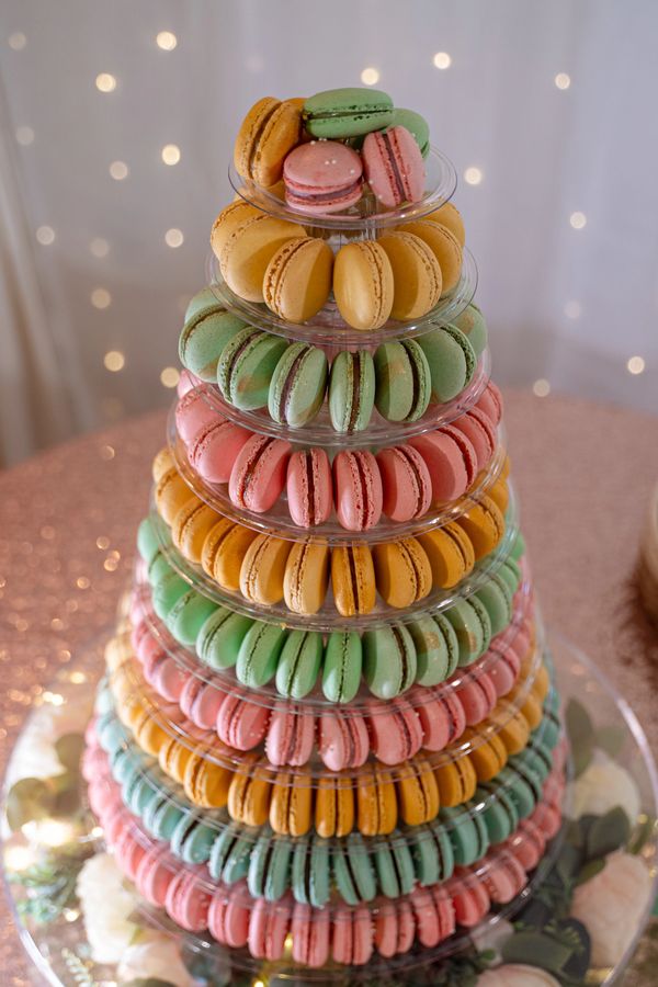 Colorful macarons arranged in a multi-tiered display tower.