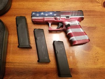 patriotic glock with three magazines that hold ammunition that you can shoot with at the range