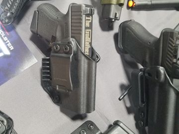 a pistol that is in a belt  holster that you can conceal carry with a magazine full of ammo 