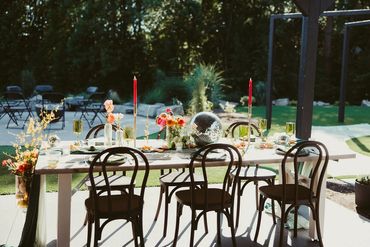 Photo of reception table with brightly colored decor and disco ball. Photo: The Wickerts Photography