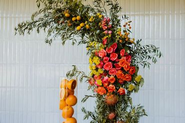 Ceremony Florals display with bright flowers and fresh citrus fruit. Photo: The Wickerts Photography