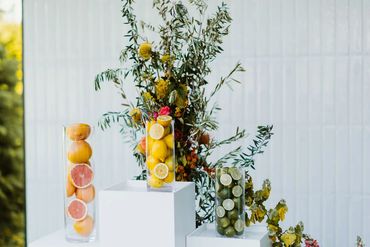 Ceremony Florals display with bright flowers and fresh citrus fruit. Photo: The Wickerts Photography