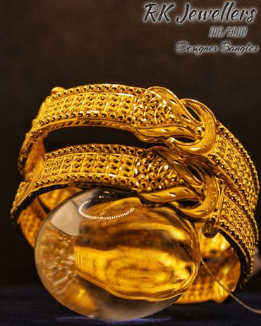 Intricately designed gold bangles from RK Jewellers.