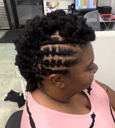 Natural locs started at our hair braiding salon are styled in a modern neat & functional updo
