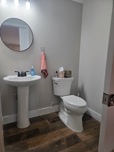 Private bathroom vanity with modern finishes in the Patt’s Place Modern Camping Suite.