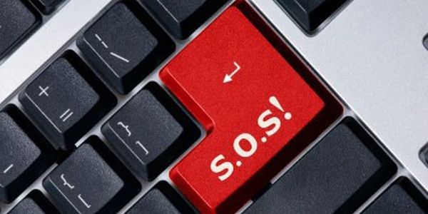 Computer keyboard with the letter 'S.O.S' prominently written on one of the keys
