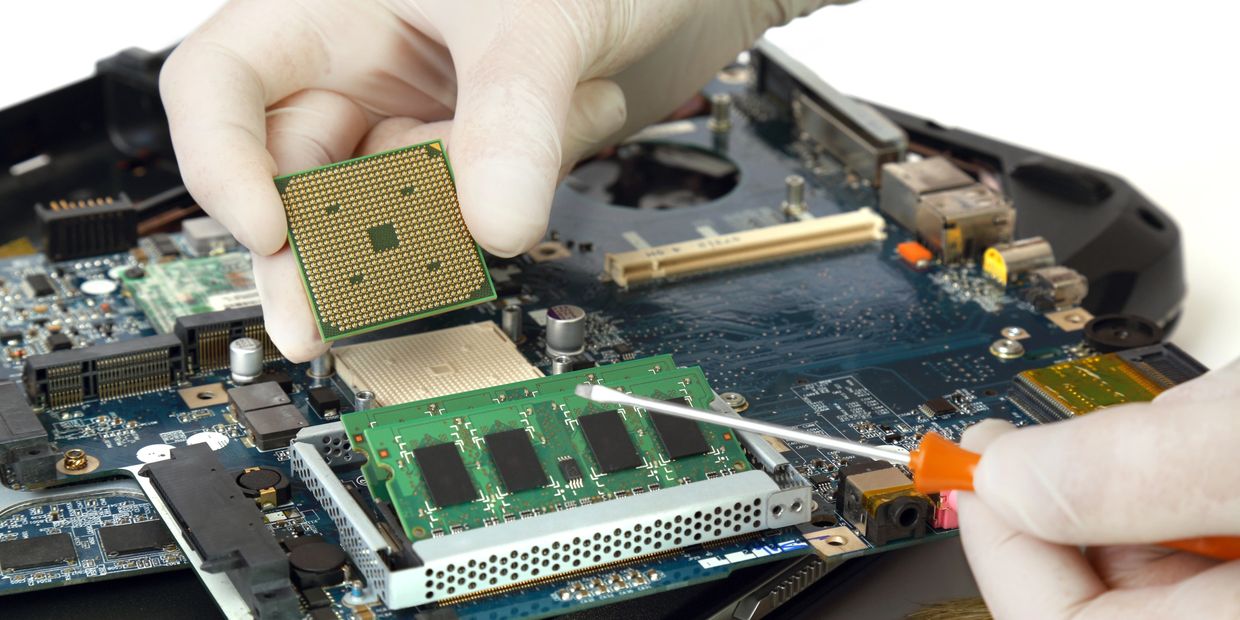 Technician working on a computer, troubleshooting and repairing hardware components