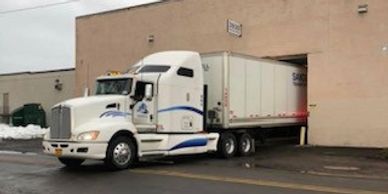 Sandell Transport truck backed into a loading dock