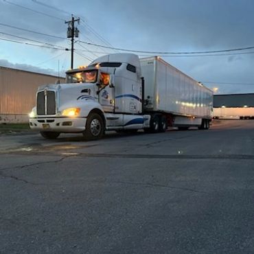 Sandell Transport Truck at a delivery location parking lot.