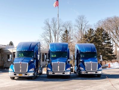 3 of Sandell Transports trucks in front of their building