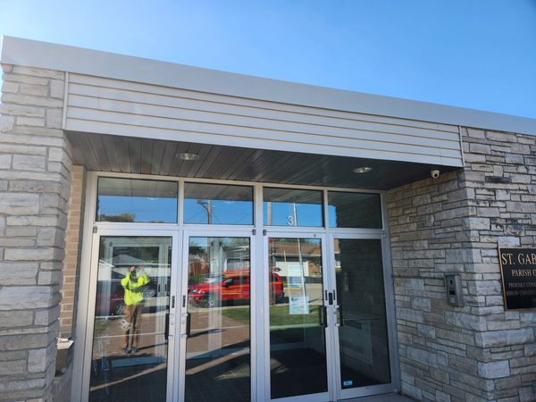 Board and Batten Siding at Lourdes Academy - Oshkosh, Wisconsin. Sierra tan metal siding panels.