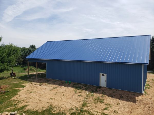 Regal Blue corrugated panels for siding on new Wautoma, WI pole shed. Snow prevention system install