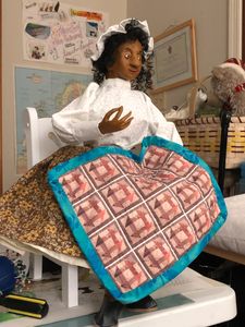 Handmade Art Doll depicting an enslaved women finishing a quilt using Monkey Wrench Block.4/2020