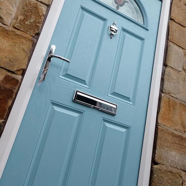 Wooden door with letterbox and small window frame