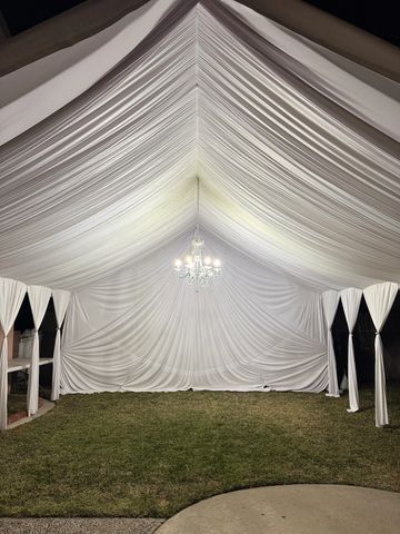 20x20 tent with white draping and chandelier with both sides open. 6' long tables.