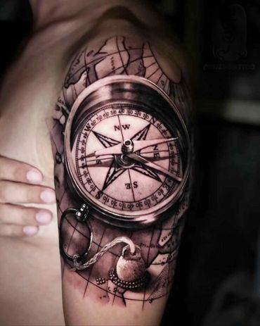 Black and grey compass tattoo on arm by Amber Tattoos Ajax ON