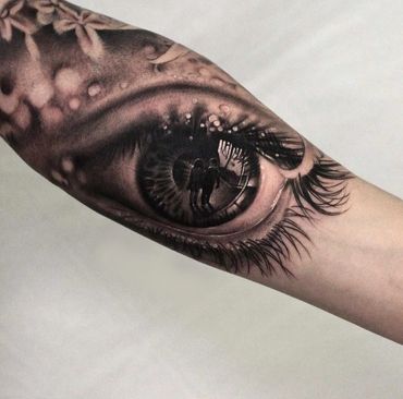 Black and grey eye sleeve tattoo by Amber Tattoos Ajax