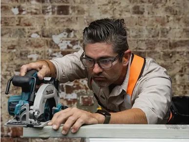 Man using a circular saw to cut wood precisely.