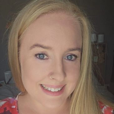 Smiling woman with blonde hair and blue eyes.