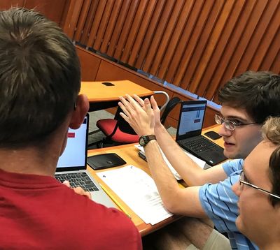 Students discuss options at a Debt Fixer budget exercise.