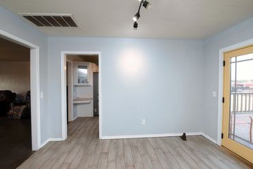 View of the dining room, with back patio, kitchen, and living room doorways visible. Home in west OK