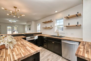 Elk City remodeled kitchen with large wood island and open shelving