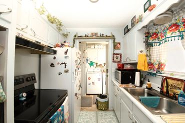 Eakly, OK galley kitchen with window and sink opening to laundry room—Western Oklahoma rural home