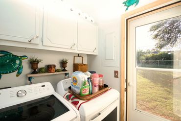 Eakly, OK laundry room with washer/dryer and exterior door to backyard—Western Oklahoma home