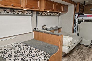 Additional sleeping areas in a recreational vehicle are featured in this well-lit photograph.