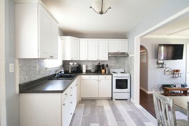 Photo of a well-lit, white kitchen of a short-term rental in western Oklahoma, listed on Airbnb