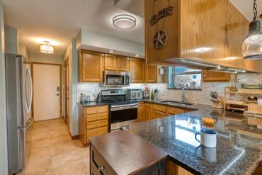 Well-lit photograph of a kitchen and the view from window of a home in Elk City, OK.
