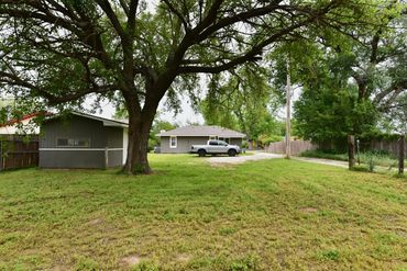 View of large backyard and storage building, showing ample parking for truck & trailers, Waynoka