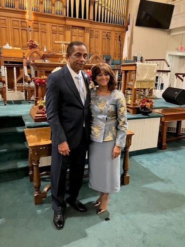 couple wearing dresses looking front