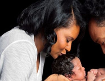 A couple taking care of their baby