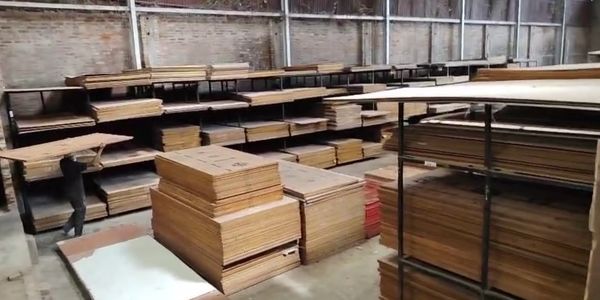 Stacks of plywood sheets in a warehouse.