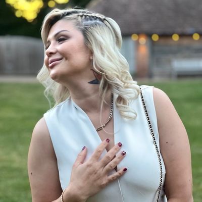 Young blonde woman smiling at the park